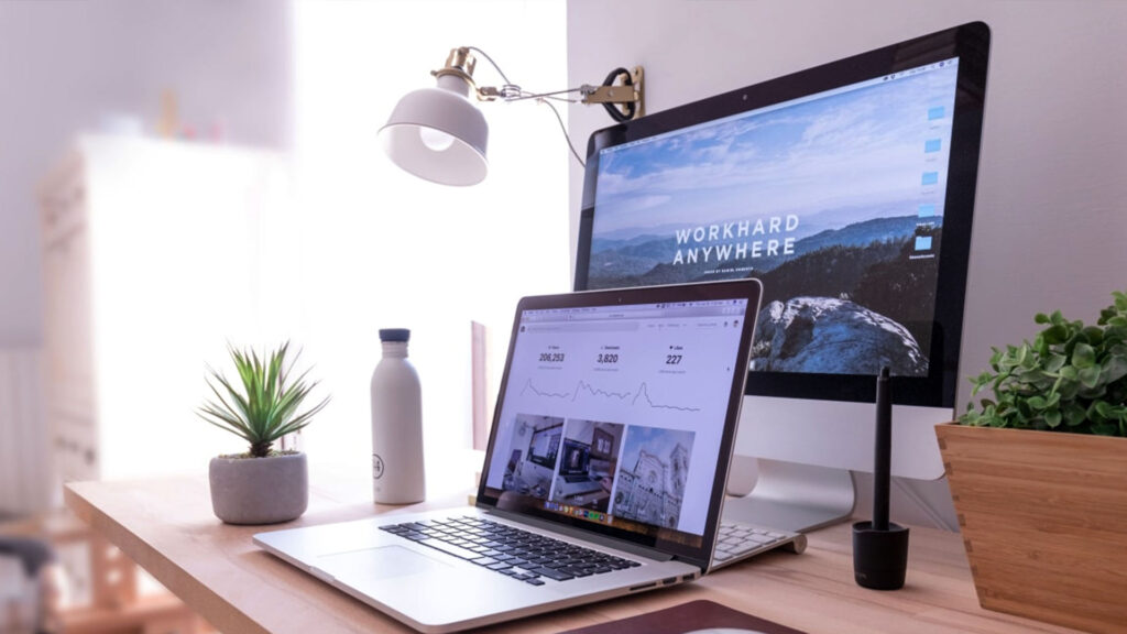 A desk with a monitor and a laptop